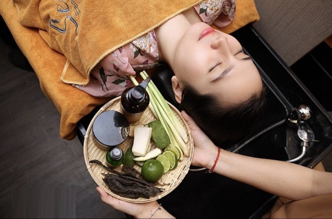 Herbal head spa treatment with fresh lemongrass, lime and herbs